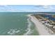 Scenic aerial shot of the coastline showcasing white sand beaches, oceanfront buildings, and crystal-clear waters at 14 Grouper Hole Dr, Boca Grande, FL 33921