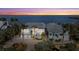 Aerial twilight view of a spacious waterfront property featuring lush tropical landscaping and breathtaking coastal views at 14 Grouper Hole Dr, Boca Grande, FL 33921