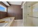 Well-lit bathroom with a separate tub and glass enclosed shower at 14 Grouper Hole Dr, Boca Grande, FL 33921