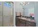 Elegant bathroom featuring a glass-enclosed shower and dark wood vanity with granite countertop and stylish fixtures at 14 Grouper Hole Dr, Boca Grande, FL 33921