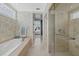 Bright bathroom with a separate tub and glass enclosed shower at 14 Grouper Hole Dr, Boca Grande, FL 33921