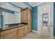 Bathroom with a wooden cabinet, granite countertop, and access to other rooms at 14 Grouper Hole Dr, Boca Grande, FL 33921