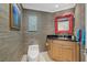 A stylish powder room with wallpaper, a framed mirror, and artwork at 14 Grouper Hole Dr, Boca Grande, FL 33921