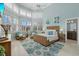 Bright bedroom featuring light blue walls, many windows, and two cozy armchairs at 14 Grouper Hole Dr, Boca Grande, FL 33921