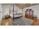 Bedroom with a four-poster bed, wooden floors, and area rug at 14 Grouper Hole Dr, Boca Grande, FL 33921