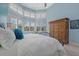 Bright bedroom with large windows, plantation shutters, and a light blue color palette at 14 Grouper Hole Dr, Boca Grande, FL 33921