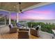 Cozy deck with comfortable seating around a fire pit, offering a relaxing atmosphere and beautiful sunset views at 14 Grouper Hole Dr, Boca Grande, FL 33921