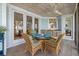 Charming porch dining area with waterfront views and outdoor access from the lovely French doors at 14 Grouper Hole Dr, Boca Grande, FL 33921