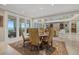 Elegant dining area adjacent to the living room, complete with balcony access and views of the sea at 14 Grouper Hole Dr, Boca Grande, FL 33921