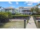 Stunning waterfront property with a private dock and expansive outdoor living spaces on a sunny day at 14 Grouper Hole Dr, Boca Grande, FL 33921