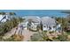 Beautiful waterfront home featuring a spacious driveway, lush landscaping, and serene surroundings at 14 Grouper Hole Dr, Boca Grande, FL 33921