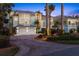 Beautiful home with a spacious driveway, lush landscaping, and a three-car garage at dusk at 14 Grouper Hole Dr, Boca Grande, FL 33921