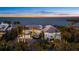 Stunning waterfront home featuring lush landscaping and breathtaking sunset views at 14 Grouper Hole Dr, Boca Grande, FL 33921