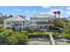 Elegant waterfront home with multiple balconies, lush landscaping, private beach access, and private dock at 14 Grouper Hole Dr, Boca Grande, FL 33921