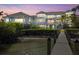 Stunning waterfront property with a private dock and expansive outdoor living spaces at dusk at 14 Grouper Hole Dr, Boca Grande, FL 33921