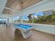 Game room with a pool table, ping pong table, and picturesque waterfront views at 14 Grouper Hole Dr, Boca Grande, FL 33921