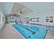 Bright indoor pool area featuring tongue and groove ceiling and floor-to-ceiling windows at 14 Grouper Hole Dr, Boca Grande, FL 33921