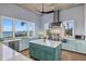 Modern kitchen with stainless steel appliances, a center island, and large windows that let in plenty of natural light at 14 Grouper Hole Dr, Boca Grande, FL 33921