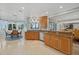Spacious kitchen with custom cabinetry, granite countertops, and an adjacent bay window dining area with water views at 14 Grouper Hole Dr, Boca Grande, FL 33921