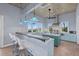 Stylish kitchen with a large island, bar seating, stainless steel appliances, and great views from many windows at 14 Grouper Hole Dr, Boca Grande, FL 33921