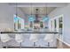 Stylish kitchen with a large island, bar seating, stainless steel appliances, and great views from many windows at 14 Grouper Hole Dr, Boca Grande, FL 33921