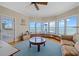 Bright living room with water view, casual seating and nautical decor at 14 Grouper Hole Dr, Boca Grande, FL 33921