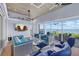 Comfortable living room with stylish furniture, a large TV, and expansive windows offering stunning waterfront views at 14 Grouper Hole Dr, Boca Grande, FL 33921