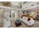 Bright living room with high ceilings, formal dining area, and staircase at 14 Grouper Hole Dr, Boca Grande, FL 33921