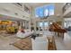 Open living room with high ceilings, water views, a grand piano, and access to the balcony at 14 Grouper Hole Dr, Boca Grande, FL 33921