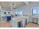 Stylish living room with a bar area, stainless steel refrigerator, and beautiful waterfront views at 14 Grouper Hole Dr, Boca Grande, FL 33921