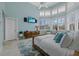 Bright bedroom with large windows, vaulted ceilings, and stylish furnishings, creating a serene retreat at 14 Grouper Hole Dr, Boca Grande, FL 33921