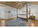 Bedroom with vaulted wood ceiling, four-poster bed, and water view at 14 Grouper Hole Dr, Boca Grande, FL 33921