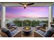 Cozy outdoor patio with a fire pit and seating area overlooking the water at 14 Grouper Hole Dr, Boca Grande, FL 33921