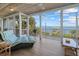 Relaxing screened-in porch featuring tile floors, a ceiling fan, and water views from the comfortable lounge seating at 14 Grouper Hole Dr, Boca Grande, FL 33921