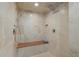 Modern walk-in shower with stone-look tile, a built-in bench, and dual shower heads at 14 Grouper Hole Dr, Boca Grande, FL 33921