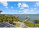 Waterfront property featuring private dock with boat lift and lush tropical landscaping at 14 Grouper Hole Dr, Boca Grande, FL 33921