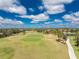 Beautiful aerial view of the golf course in the community with lush landscaping and ponds at 142 Palazzo Ct, North Venice, FL 34275