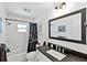 Charming bathroom with a black and white theme, featuring a shower-tub combo and modern fixtures at 150 Fiesole St, Venice, FL 34285