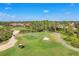 An aerial view of the community's stunning golf course with mature trees at 1526 Creek Nine Dr, North Port, FL 34291