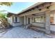 Inviting front porch with stone pillars and a ceiling fan, perfect for relaxing outdoors at 153 N Adams Dr, Sarasota, FL 34236