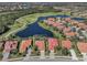Aerial view showcases this home's location on a lake near a golf course at 162 Treviso Ct, North Venice, FL 34275