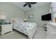 Bright bedroom featuring coastal decor, ceiling fan, light green paint, and comfortable furnishings at 162 Treviso Ct, North Venice, FL 34275