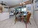 Dining area with an opening to the living room and a view of the lanai at 162 Treviso Ct, North Venice, FL 34275