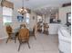 Cozy dining area with a glass table, wicker chairs, and natural lighting at 162 Treviso Ct, North Venice, FL 34275