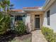 Inviting front entrance featuring a well-kept garden and a charming entryway door at 162 Treviso Ct, North Venice, FL 34275
