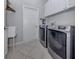 Laundry room features a side-by-side washer and dryer plus storage at 162 Treviso Ct, North Venice, FL 34275