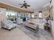 Bright living room with a ceiling fan, tile flooring, and comfortable seating at 162 Treviso Ct, North Venice, FL 34275