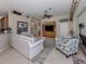 Comfortable living room with neutral paint, tile floors, ceiling fan and stylish decor at 162 Treviso Ct, North Venice, FL 34275