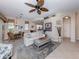 Open concept living room featuring tile flooring, a ceiling fan, and an adjacent dining area at 162 Treviso Ct, North Venice, FL 34275