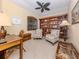Comfortable home office with built-in shelves, natural light, and relaxed seating arrangements at 162 Treviso Ct, North Venice, FL 34275